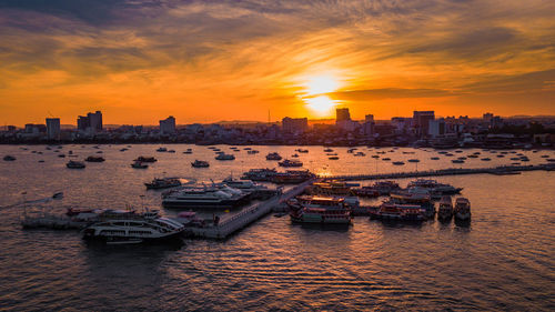 View of city buildings against sky during sunset