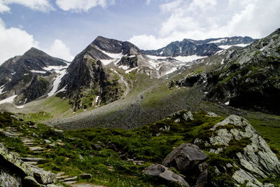 Scenic view of mountains against cloudy sky