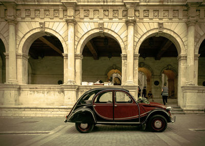 Vintage car against historic building