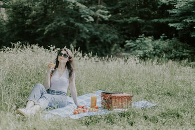 Young brunette girl at a picnic in the forest.