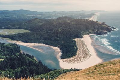 High angle view of sea and mountains against sky