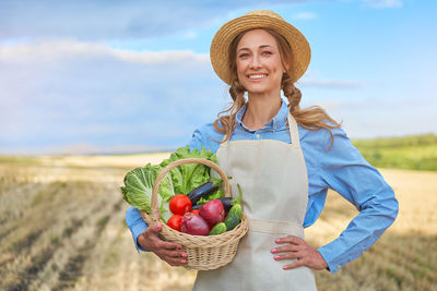 Portrait of smiling young woman holding basket