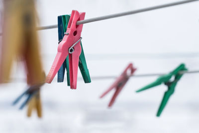 Close-up of colorful clothespins hanging on clothesline