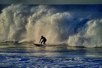 People surfing in sea