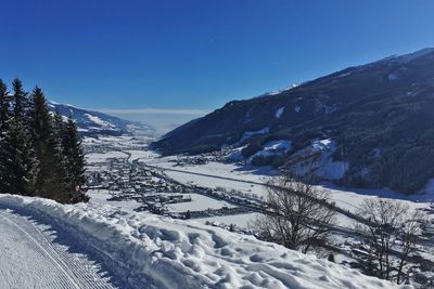 Scenic view of snowcapped mountains against clear blue sky