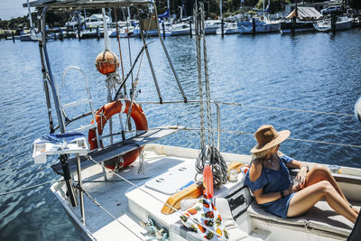 High angle view of woman relaxing in sailboat