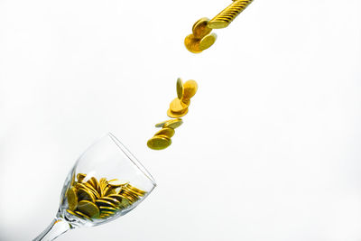 Close-up of yellow bottle against white background