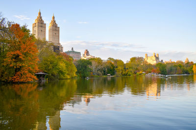 Reflection of trees and buildings in lake