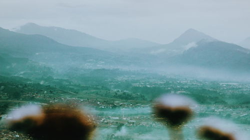 Scenic view of mountains against sky during rainy season