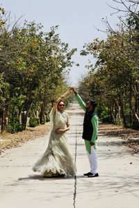 Rear view of couple kissing against trees