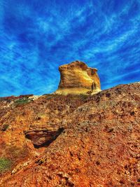 Low angle view of rock formation against blue sky