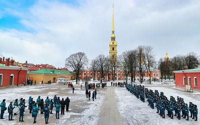 Group of people in front of building against sky