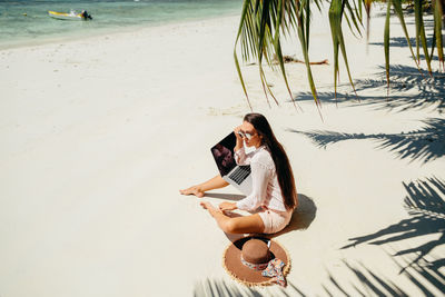 Woman sitting on beach