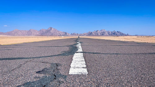 Scenic view of desert against clear blue sky