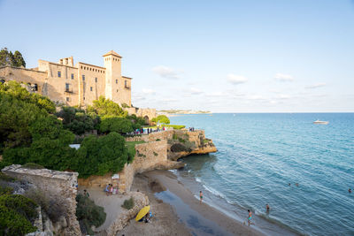 Panoramic view of sea and buildings against sky