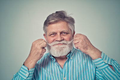 Portrait of man against blue background