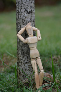 Close-up of woman on tree trunk