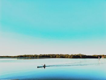 Scenic view of lake against clear sky during winter