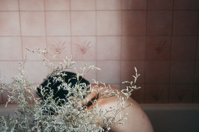 Boy sitting in bathtub at home