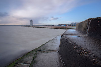 Road by sea against sky in city