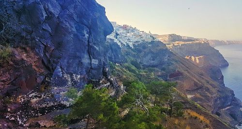 Scenic view of sea and mountains against sky