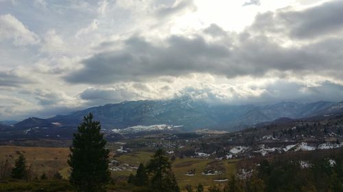 Scenic view of mountains against cloudy sky