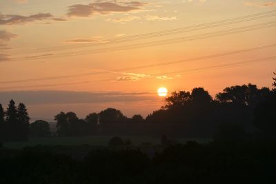 Silhouette trees against sky during sunset