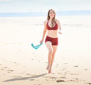 Full length of a young man on beach