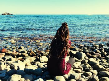 Rear view of woman looking at sea shore