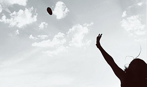 Low angle view of people against sky