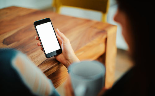 Midsection of woman using mobile phone