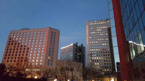 Low angle view of buildings against clear blue sky