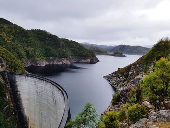 Scenic view of river against cloudy sky