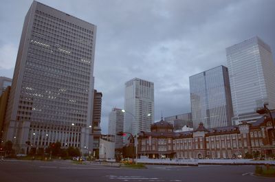 City skyline against cloudy sky