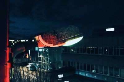 Illuminated city against sky at dusk