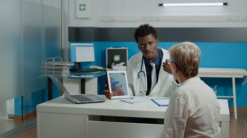 Doctor examining senior patient in clinic