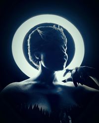 Close-up of statue against illuminated background