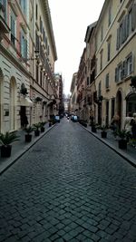 Street amidst residential buildings against sky