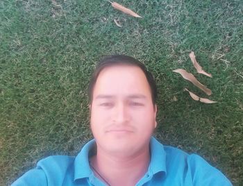 High angle portrait of boy on grassy field