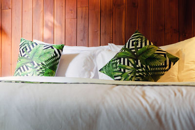 Close-up of green table on bed against wall at home