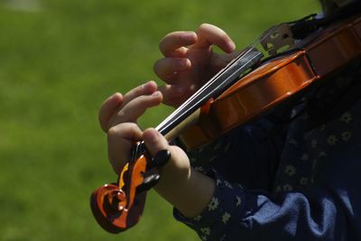 Midsection of woman playing violin