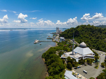 High angle view of townscape by sea against sky