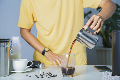 Midsection of man working on table