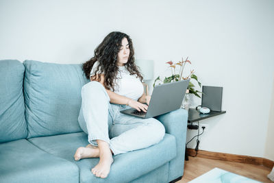 Young woman using laptop at home