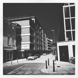 Street amidst buildings against sky in city