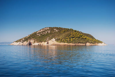 Scenic view of sea against clear blue sky