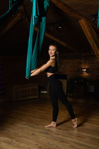 Full length portrait of young woman standing in tunnel