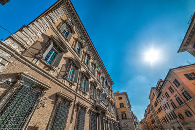 Low angle view of buildings against sky on sunny day