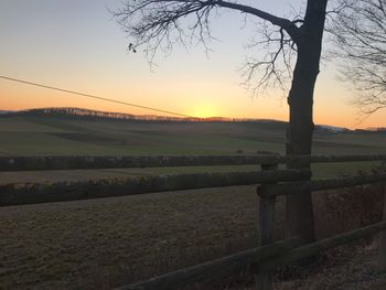 Scenic view of field against sky during sunset