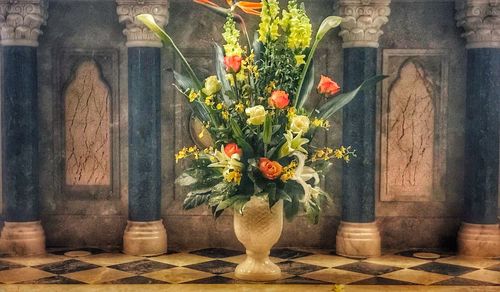 Flowers in vase against window